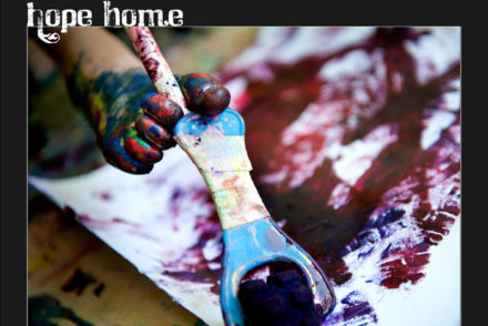 paint-covered foot holding paintbrush, painting